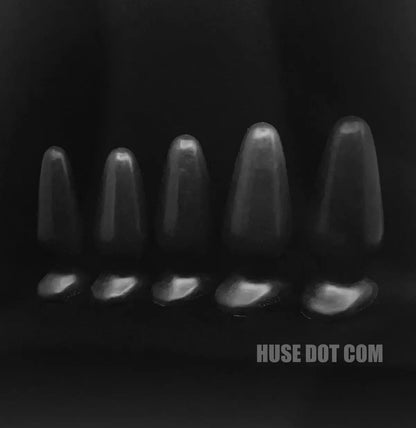 Black and white image of five butt plug sizes background with 'HUSE DOT COM' branding.